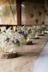 Festive wedding decoration of table with flowers. Rustic or boho style