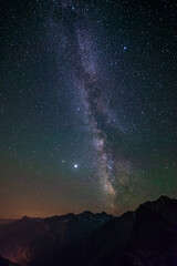 The Milky Way galaxy and the stars in the night sky view from high altitude mountain range, the...