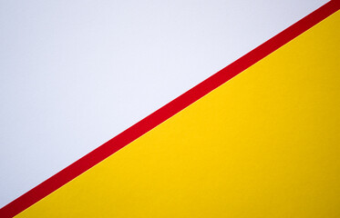 Diagonally divided textured colored paper background. White and yellow template with red line