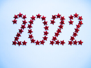 Year 2022 made of red stars on a gray background. New Year. Christmas. Celebration. View from...