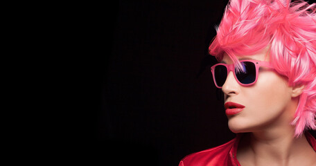 Beauty fashion model girl with stylish pink hair wearing modern sunglasses. Profile closeup...
