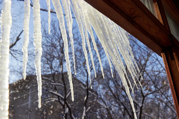 icicles hanging from the roof on sunny day