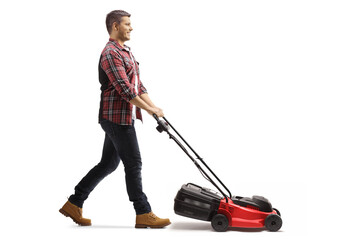 Full length profile shot of a young man working with a lawnmower