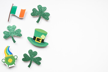 Shamrocks and St Patricks Day symbols on white background with copy space