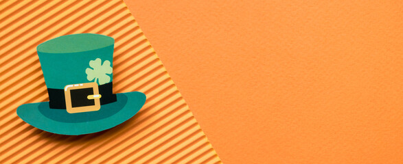 St Patricks Day green hat on orange background banner with copy space