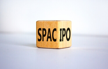 SPAC vs IPO symbol. Wooden cube with words 'SPAC, special purpose acquisition company' and 'IPO,...