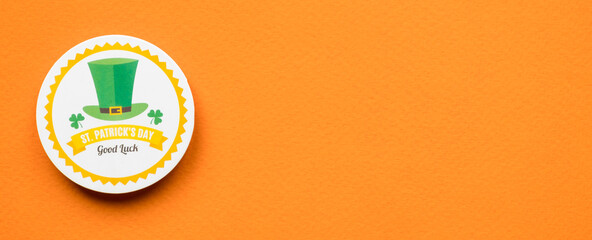 St Patricks Day green hat on orange background banner with copy space
