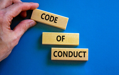 Code of conduct symbol. Concept words 'Code of conduct' on wooden blocks on a beautiful blue...