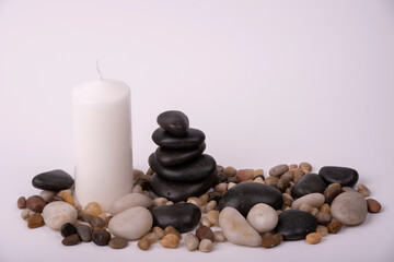 relaxation therapy with a candle between stones