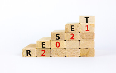 Business concept of 2021 new year reset. Wooden blocks with words 'Reset 2021'. Beautiful white background, copy space. 2021 new year reset symbol.