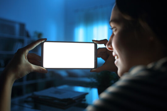 Lady Showing And Watching Horizontal Phone Screen In The Night