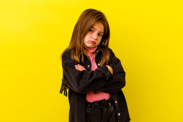 Little caucasian girl isolated on yellow background who is bored, fatigued and need a relax day.