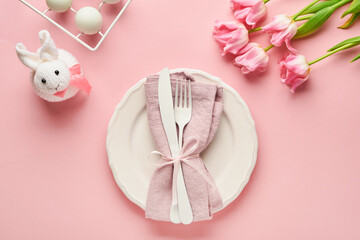 Easter table setting with floral decor on pink table. Elegance dinner. Mock up. Top view.