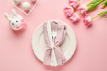 Easter table setting with floral decor on pink table. Elegance dinner. Mock up. Top view.