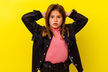 Little caucasian girl isolated on yellow background celebrating a victory or success, he is surprised and shocked.