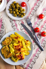 Roast pork chops baked with potato and cheese.