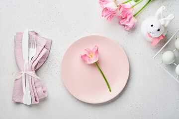 Easter table setting with floral decor on gray table. Elegance dinner. Mock up. Top view.