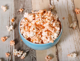 Cheese popcorn in bowl on wooden background
