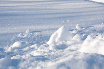 Fototapeta na wymiar Snow. Snow drifts close up. Snowy surface during the day. Winter snow texture.