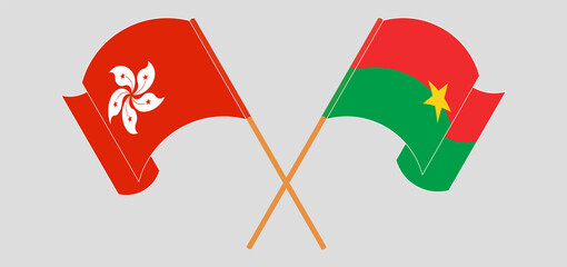 Crossed and waving flags of Hong Kong and Burkina Faso