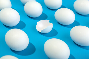 broken pattern with eggs and egg shell on blue background