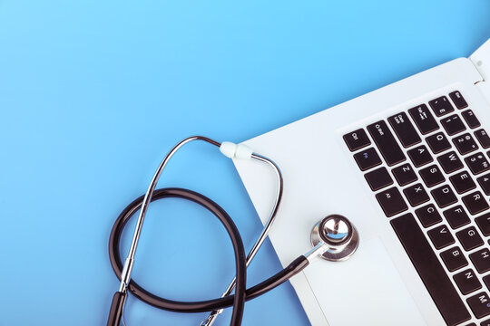 stethoscope on a laptop on a blue background. online medicine concept. computer repair concept. 