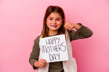 Fototapeta na wymiar Little girl holding a happy mothers day banner isolated on pink background