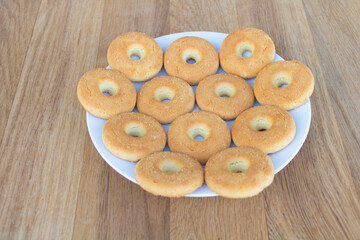 Aome tasty biscuits in a plate on a wooden background