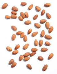 Almond nuts scattered heap on white background, top view. Almond nuts background. Healthy nutritious snack