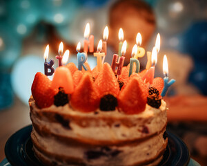birthday cake with candles against blue balloons
