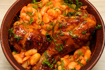 Ready-made, baked chicken legs in spices with beans. Boiled beans and chicken legs are served hot...