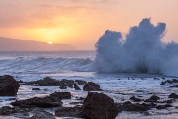 USA, Hawaii, Oahu, North Shore and waves crashing ashore right at sunset