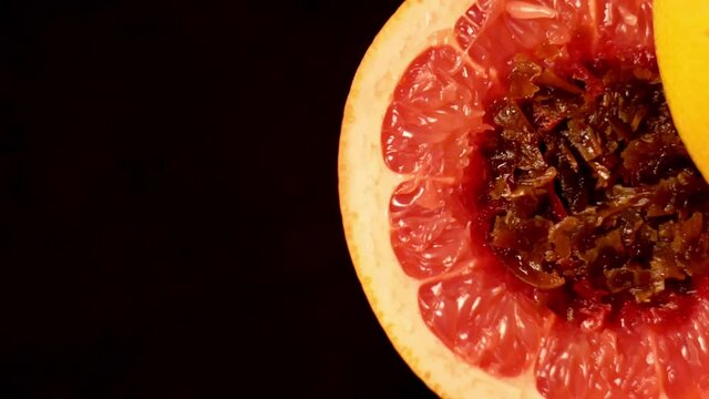 Process of making a red grapefruit halves with stuffed with tobacco for a traditional shisha hookah