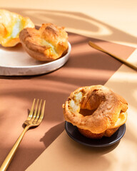 Yorkshire pudding on a brown background. Hard light, shadows