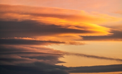 Beautiful dark orange sky with clouds after sunset. Nature sky sunset background.
