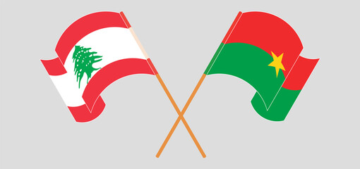 Crossed and waving flags of the Lebanon and Burkina Faso