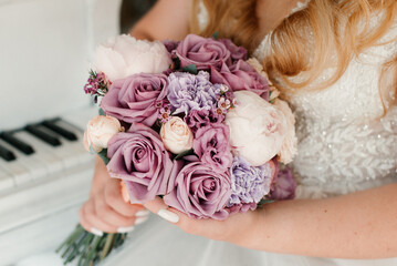the bride in a white dress is holding a bridal bouquet