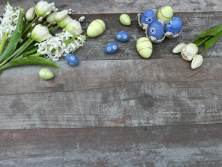 Ostereier mit Tulpen und Hyazinthen auf Holzhintergrund