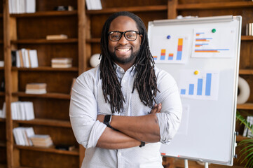 Cheerful multiethnic man with a dreadlocks is online tutor, teacher, a smiling African-American...