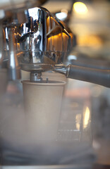 closeup of holders and steam in professional group head espresso coffee machine