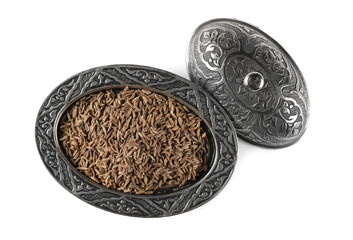 Pile of cumin, caraway seeds in embroidered, embossed silverware pot, bowl isolated on white background, top view