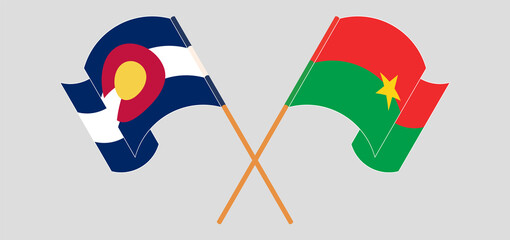 Crossed and waving flags of The State of Colorado and Burkina Faso