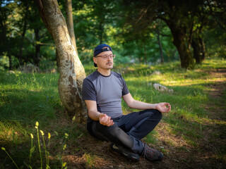 Naklejka na ściany i meble Yoga meditation in the woods.