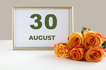 Day of the month calendra photo frame and yellow rose on the table