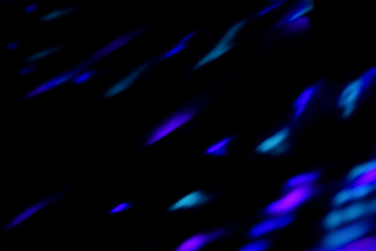 Blur colorful neon light leaks on black background. Defocused illuminated abstract futuristic texture for using over photos as overlay or screen filter