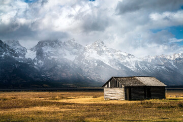 autumn at the historic Moulton barn in Mormon Row with snow capped mountain on the background in Grand Teton national Park in Wyoming.