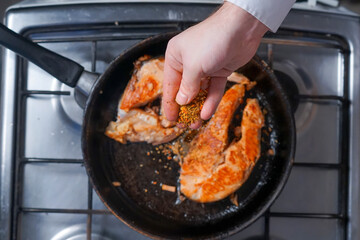 Salmon steak is cooked in a pan
