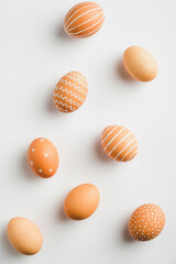 Happy Easter minimal flat lay style composition. Simple Striped and dotted Easter eggs on white background.