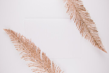 white sheet of paper with gold feathers background for postcard