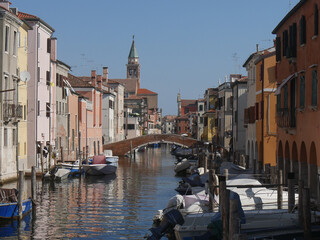 Chioggia, Vena Canal with colorful ancient buildings on both sides and crossed by ancient bridges